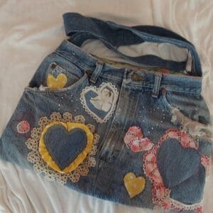 Denim bag with heart-shaped fabric patches