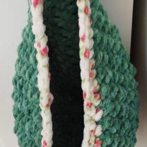 Green crocheted hanging pouch with floral trim