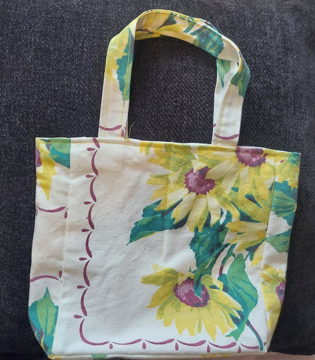 Floral-patterned tote bag with green and yellow flowers on a light background.