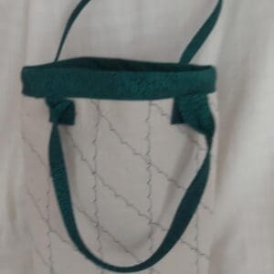 White quilted tote bag with teal straps